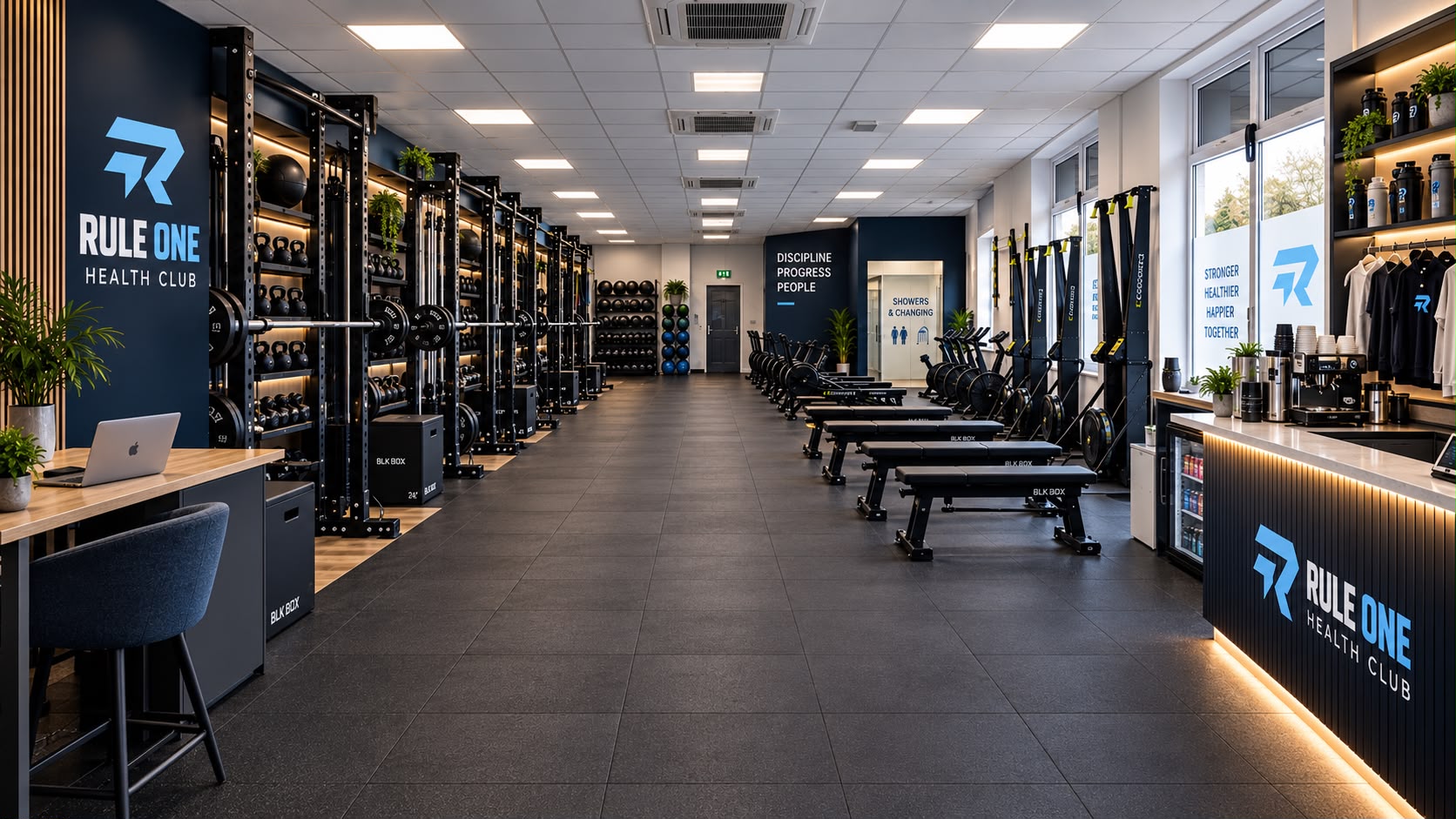 Inside the Rule One studio: racks and free weights along the left, conditioning machines and a service counter along the right